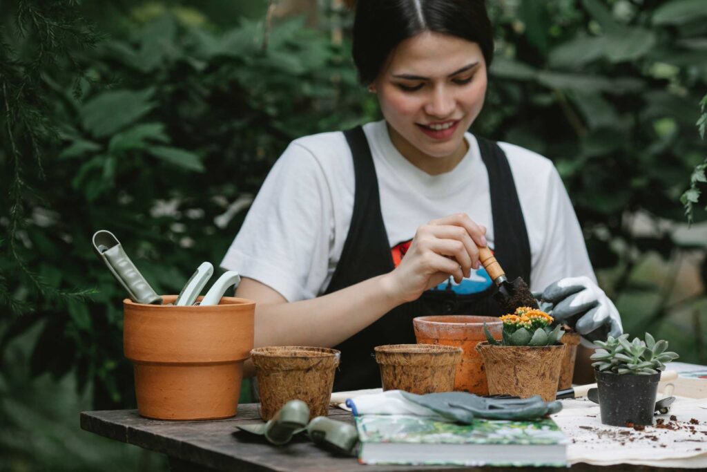 a girl repoting cactus