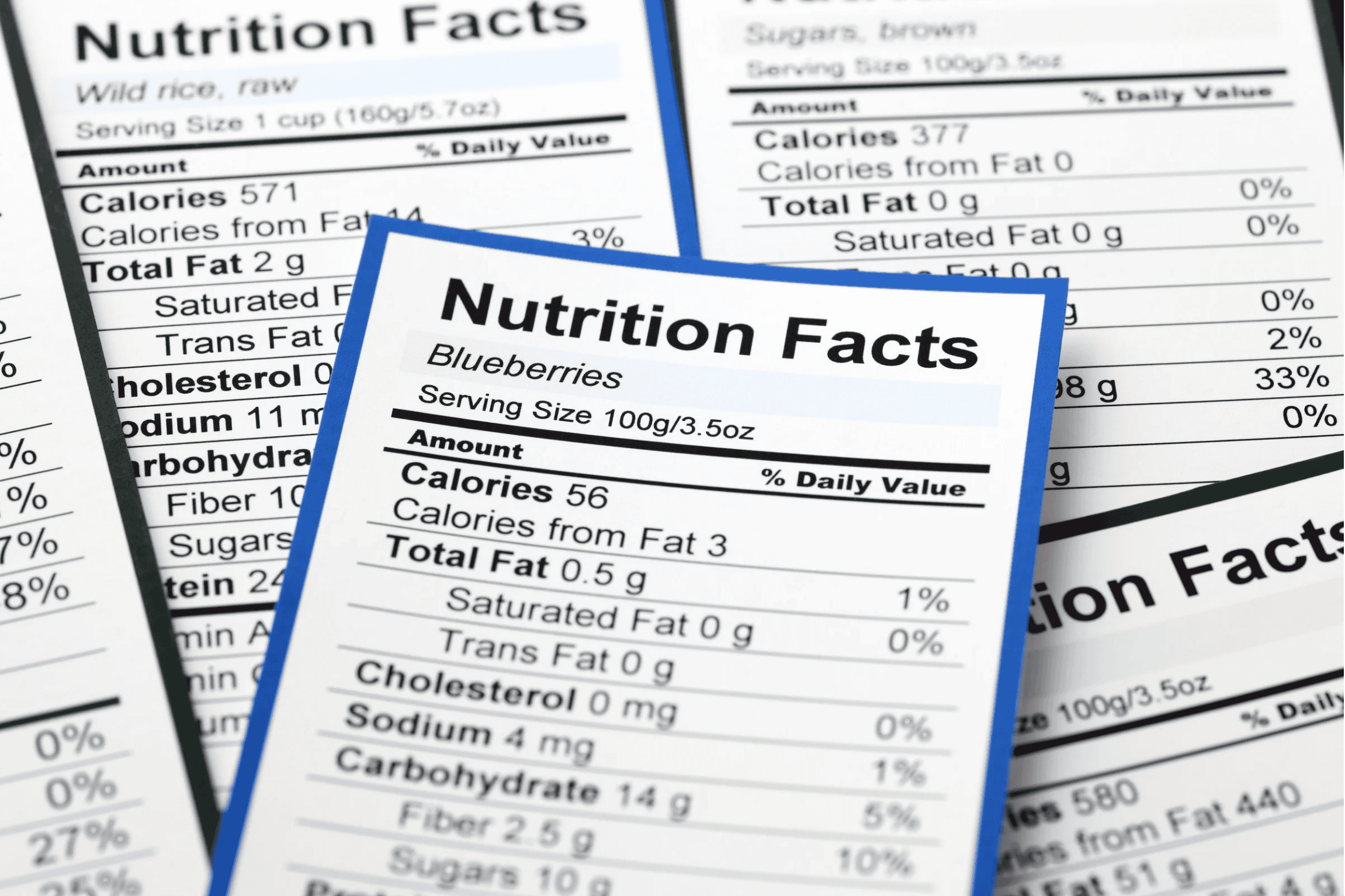 Multiple nutrition facts labels for different foods, including blueberries and wild rice
